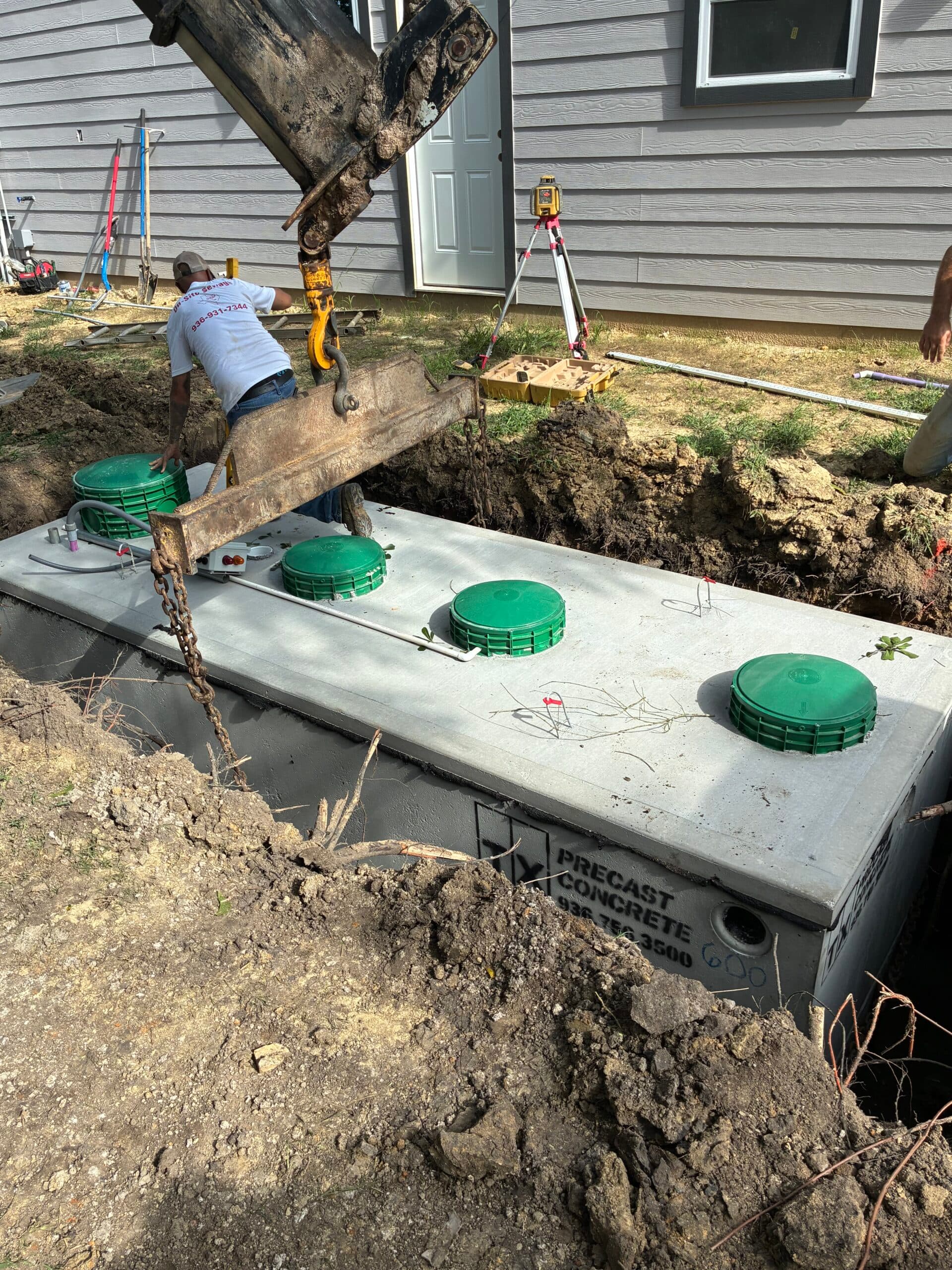 Septic tank placement in progress on a job site